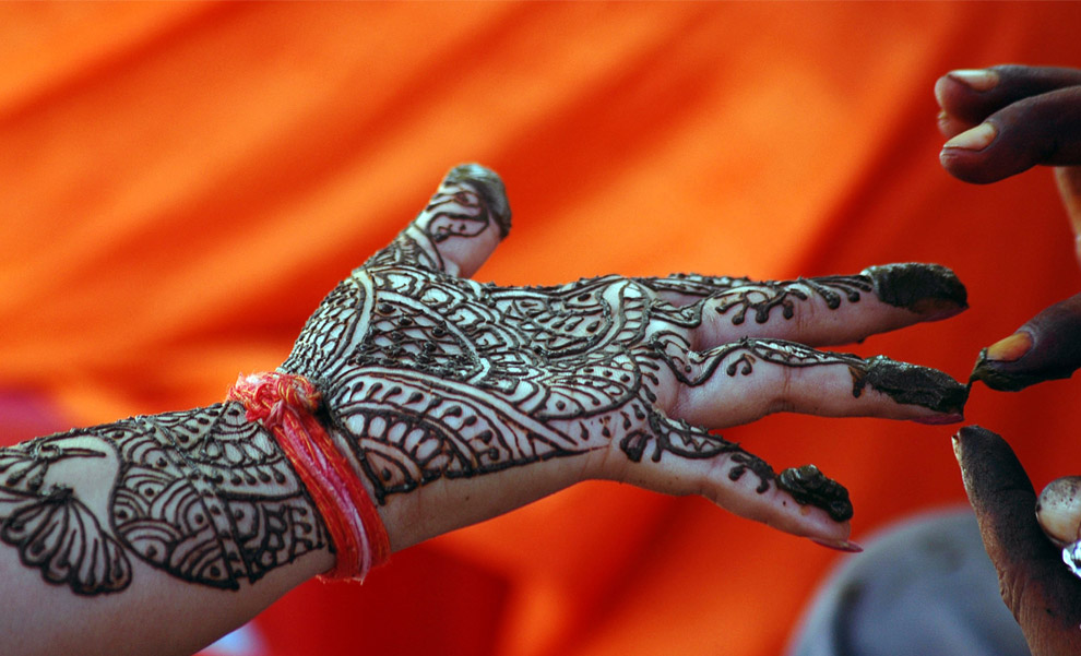 Ind A Hindu woman has her hand painted with henna during the Teej festival in the northern Indian city of Allahabad September 2, 2008 REUTERSJitendra Prakash