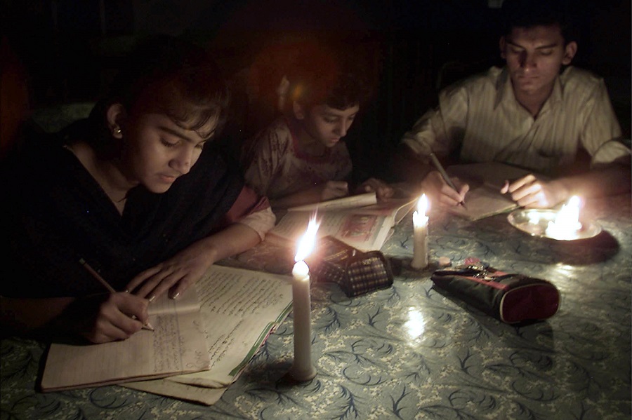 PAKISTANI STUDENTS STUDY BY CANDLELIGHT DUE TO POWER FAILURE IN KARACHI.